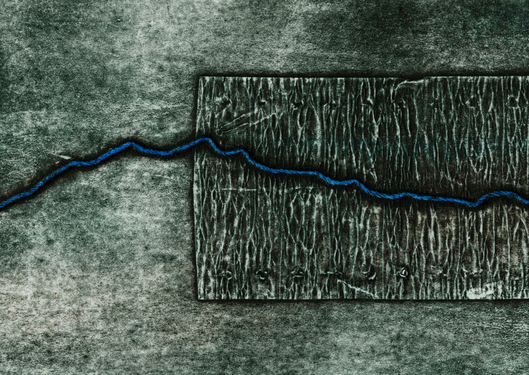 Close up section of a textural collagraph print and blue line tracing the path